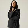 a woman wearing a black raincoat with cream headband and over the shoulder bag