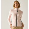 A woman wearing a light pink full-zip fleece jacket with black zippers, paired with khaki pants, photographed against a neutral light gray studio background.