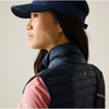 a women closeup wearing a navy cap and andreson gilet navy with a pink tshirt