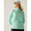 A woman wearing a light mint green long-sleeve quarter-zip athletic pullover and a white baseball cap, photographed against a plain light gray studio background.