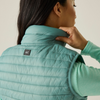 a woman wearing a ivy moss gilet with fleece underneath and black logo on back in small