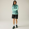 a woman wearing ivy moss gilet with green fleece, black shorts and white socks and black shoes