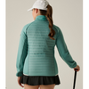 a woman wearing a green jacket, black skirt and white cap on offwhite background