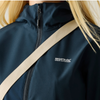 Close-up of a navy fleece jacket with a vertical zippered pocket and a white zipper pull, shown against a light neutral background.