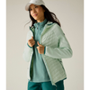 A woman wearing a ocean mist jacket over a quarter-zip pullover, paired with light blue shorts, shown against a solid light beige background.